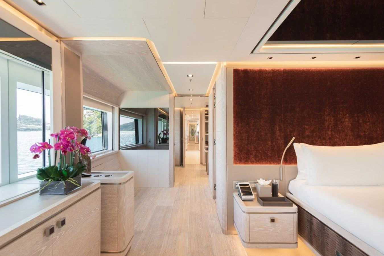 A luxurious stateroom with modern decor and large windows offering scenic views. aboard PICK UP Yacht for Sale