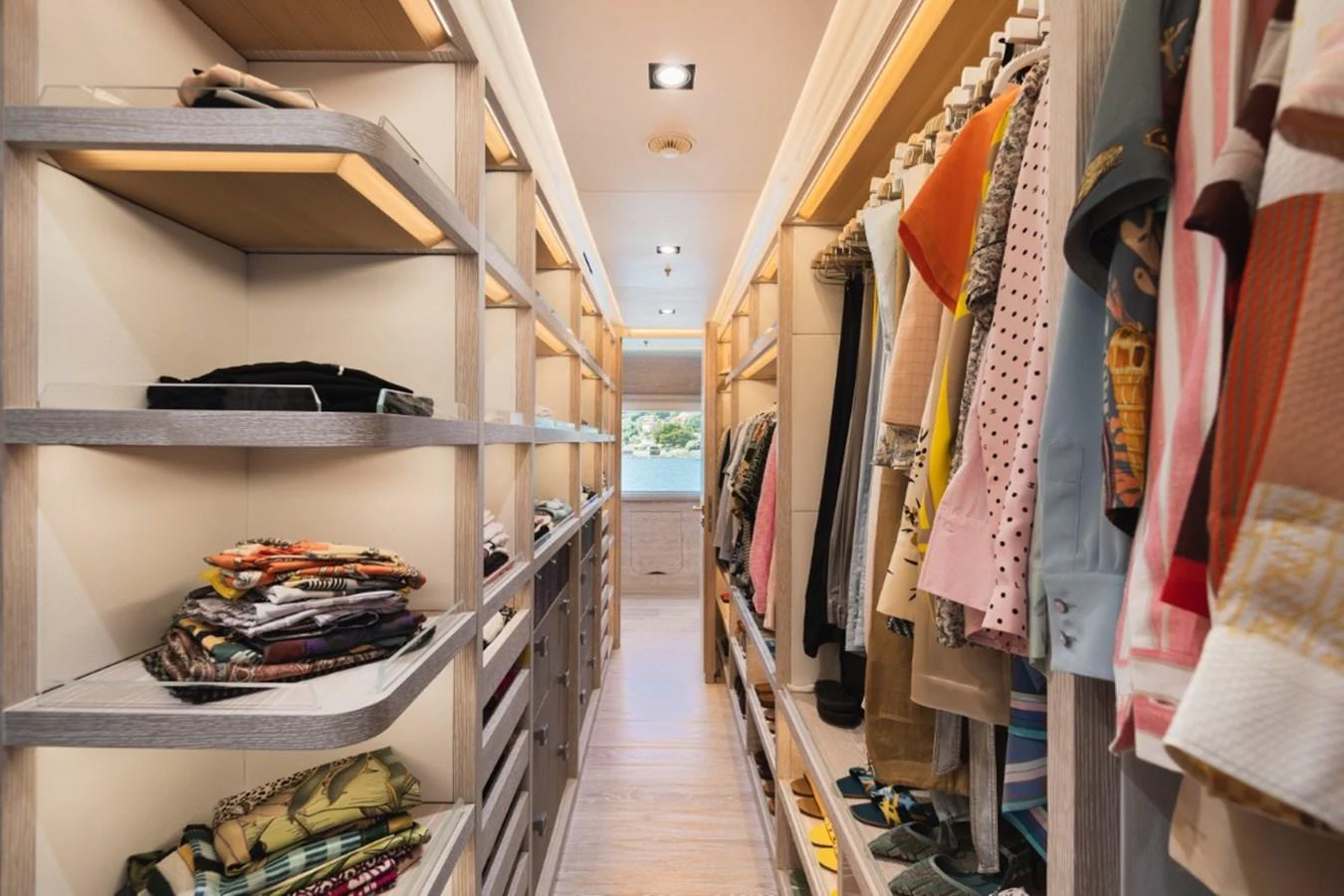 A luxurious walk-in closet with ample storage space and neatly organized clothing. aboard PICK UP Yacht for Sale