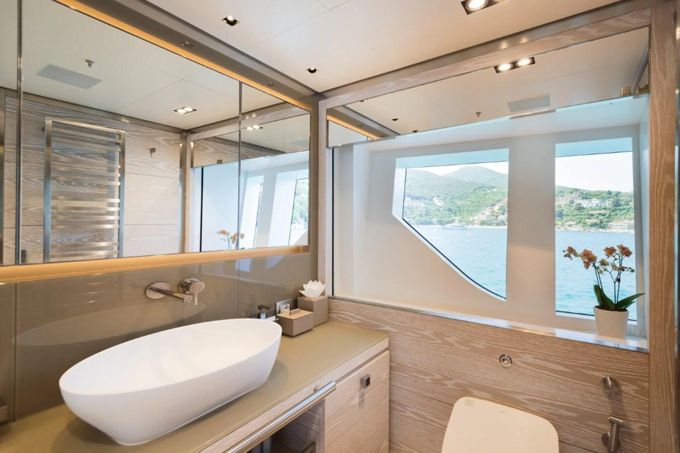 The yacht's bathroom features a modern design with a large window offering scenic views. aboard PICK UP Yacht for Sale