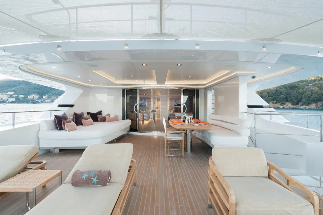 The aft deck features a spacious lounging area with plush seating and a dining table, perfect for relaxation and entertaining. aboard PICK UP Yacht for Sale