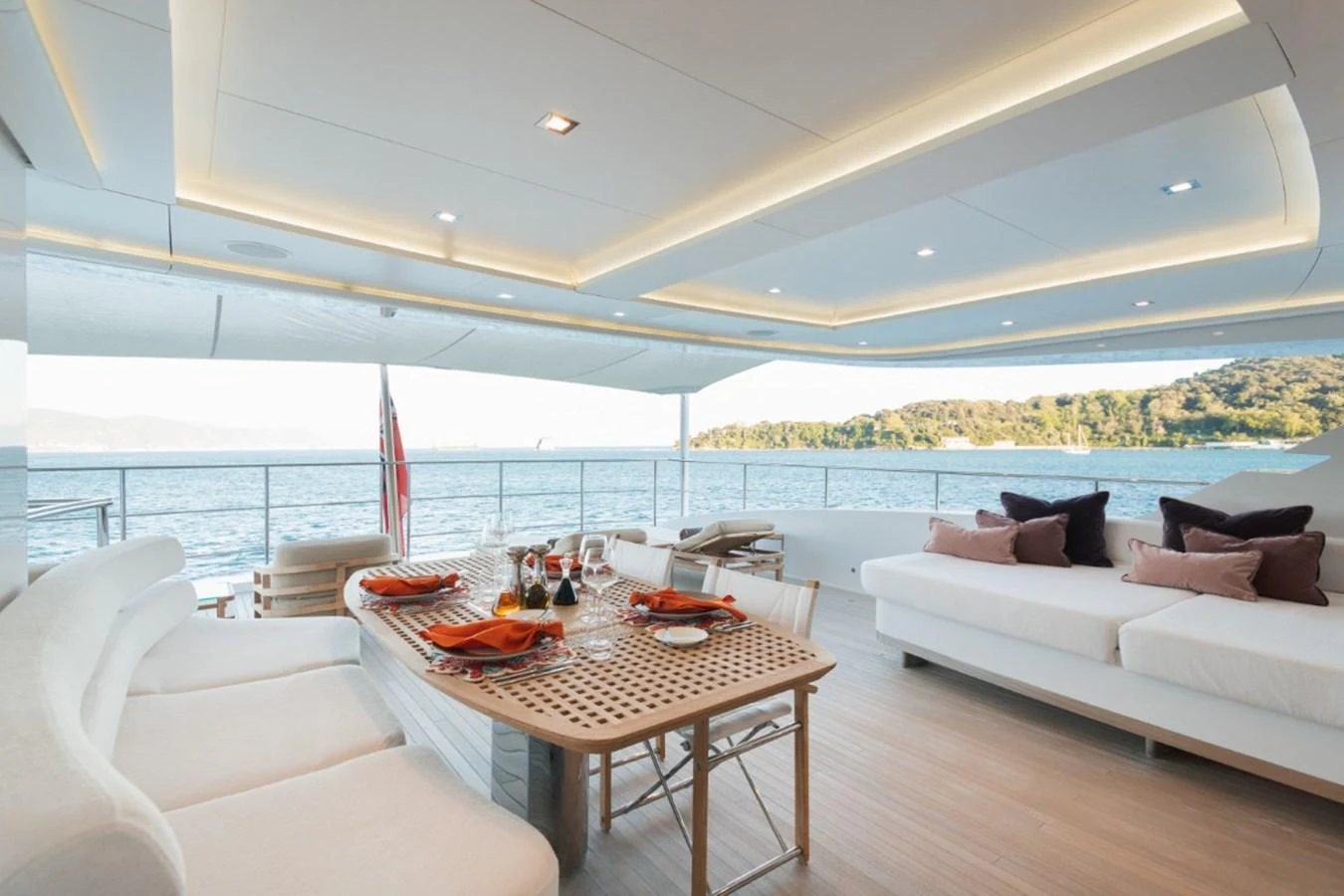 The aft deck offers a luxurious dining area with stunning ocean views and plush seating. aboard PICK UP Yacht for Sale