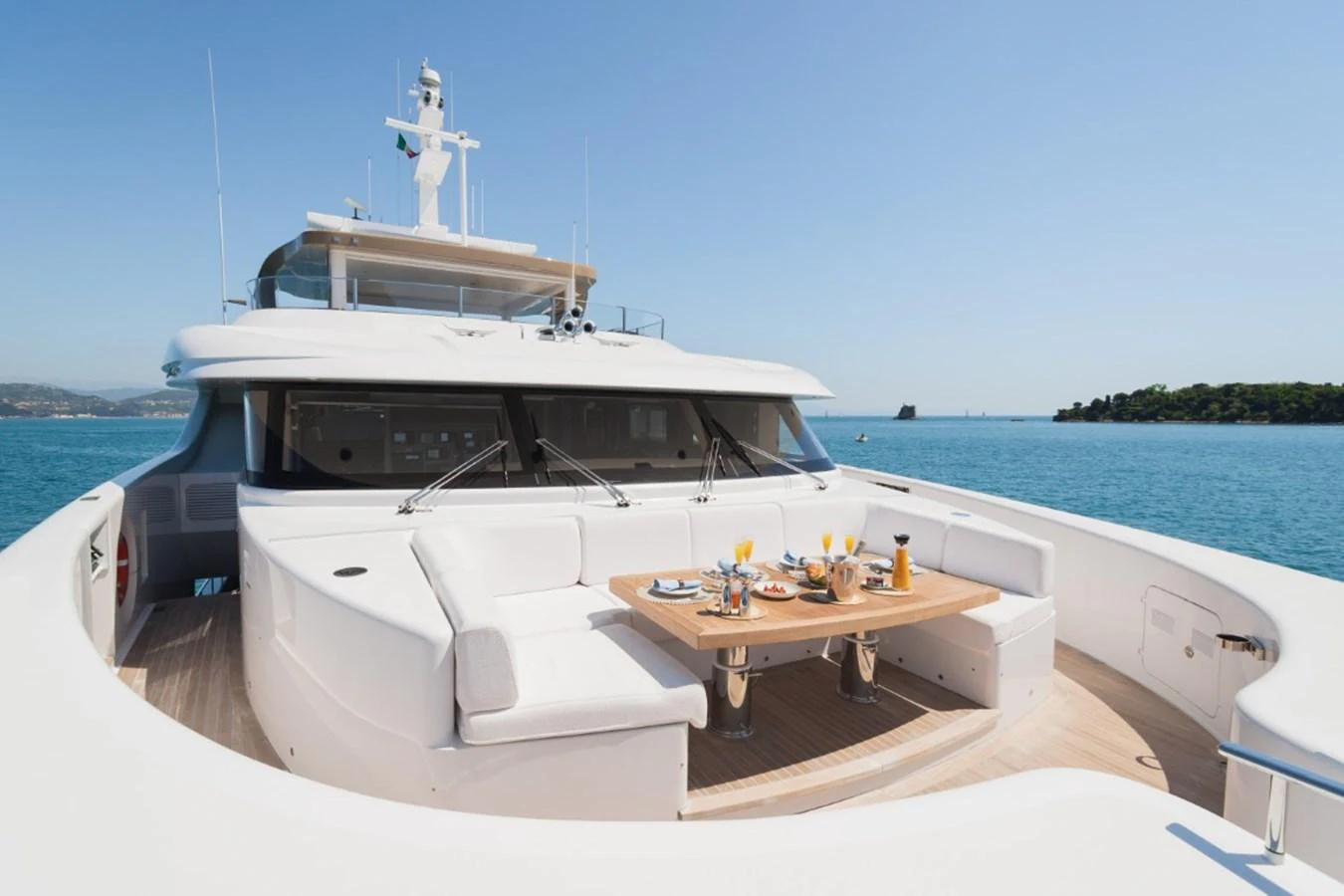 The yacht's foredeck features a luxurious seating area with a dining table, perfect for enjoying meals with a stunning ocean view. aboard PICK UP Yacht for Sale