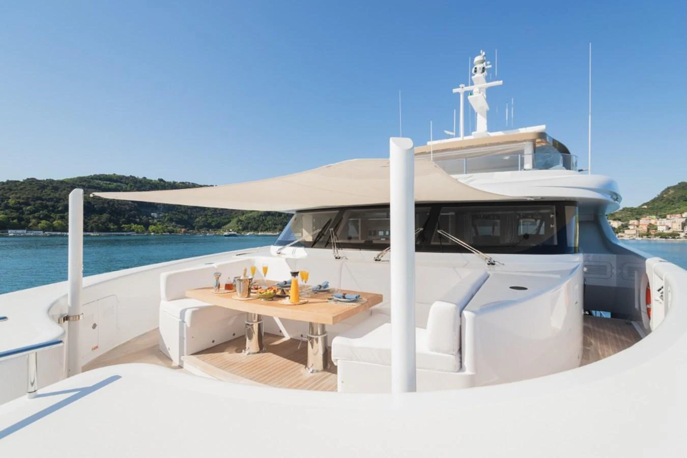 The foredeck features a stylish dining area under a sunshade, perfect for alfresco meals with a view. aboard PICK UP Yacht for Sale