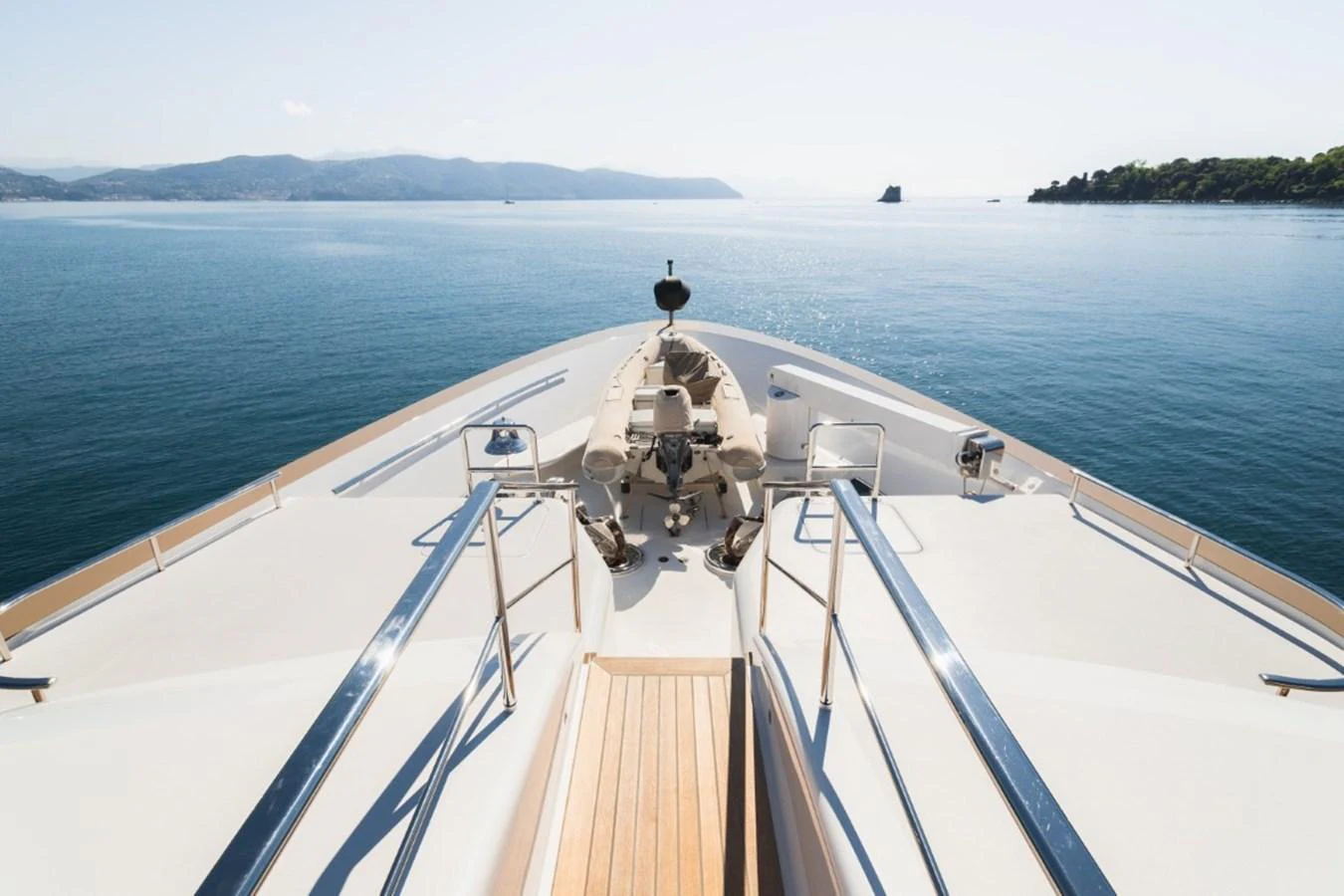 The yacht's bow offers a serene view of the open sea and distant coastline. aboard PICK UP Yacht for Sale