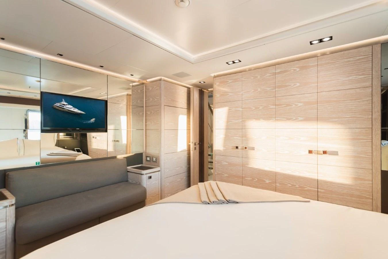 The stateroom features a modern design with light wood paneling and a comfortable seating area. aboard PICK UP Yacht for Sale