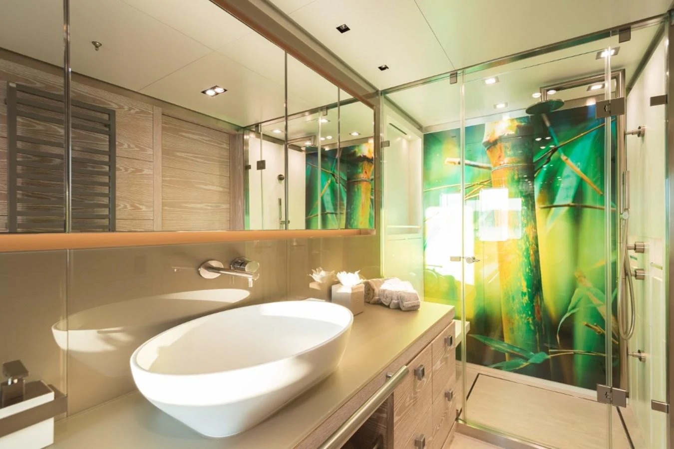 The yacht's bathroom features a modern design with a large vessel sink and a vibrant glass shower enclosure. aboard PICK UP Yacht for Sale