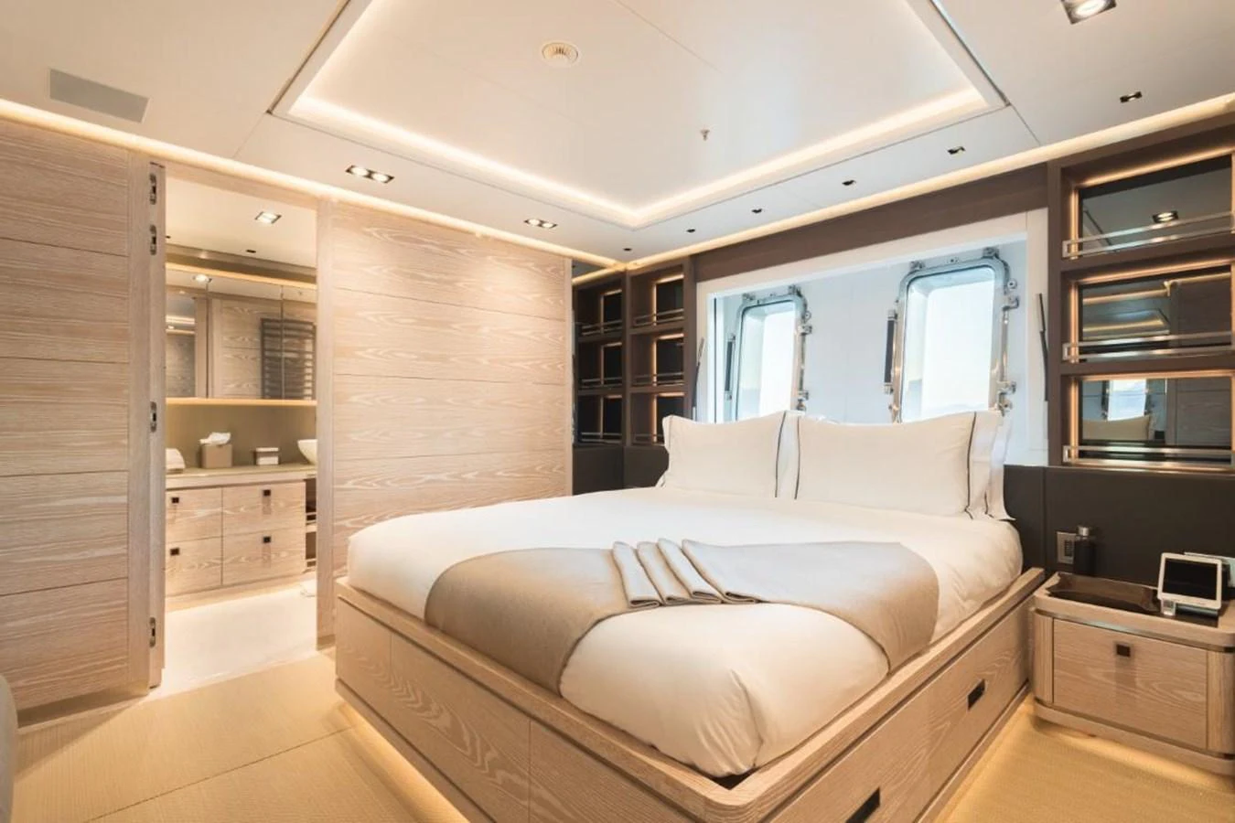 The master stateroom features a luxurious bed with elegant lighting and ample storage space. aboard PICK UP Yacht for Sale