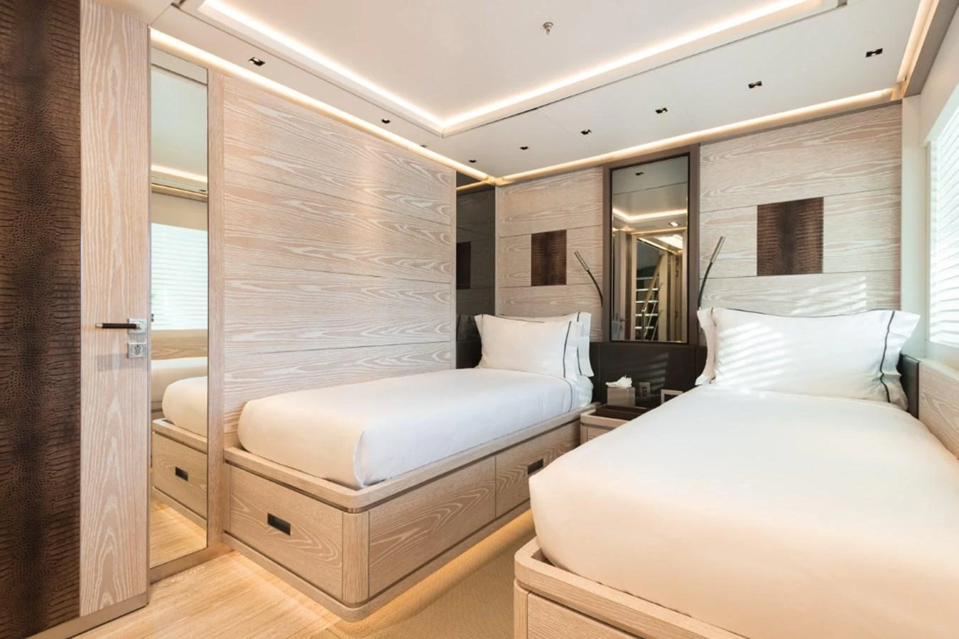 The guest stateroom features twin beds with modern wooden finishes and ample natural light. aboard PICK UP Yacht for Sale