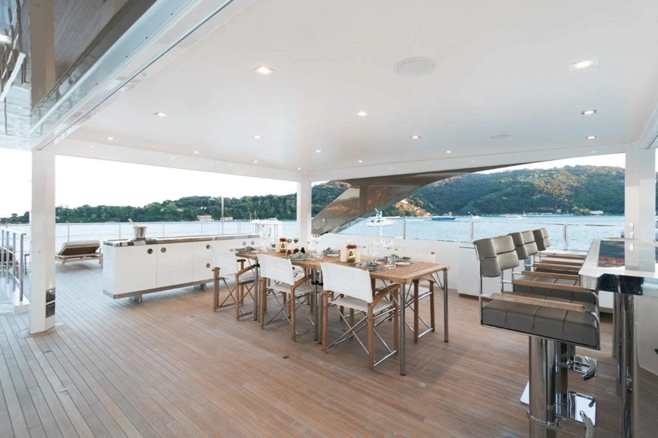 The aft deck features a spacious dining area with a stunning view of the surrounding waters. aboard PICK UP Yacht for Sale