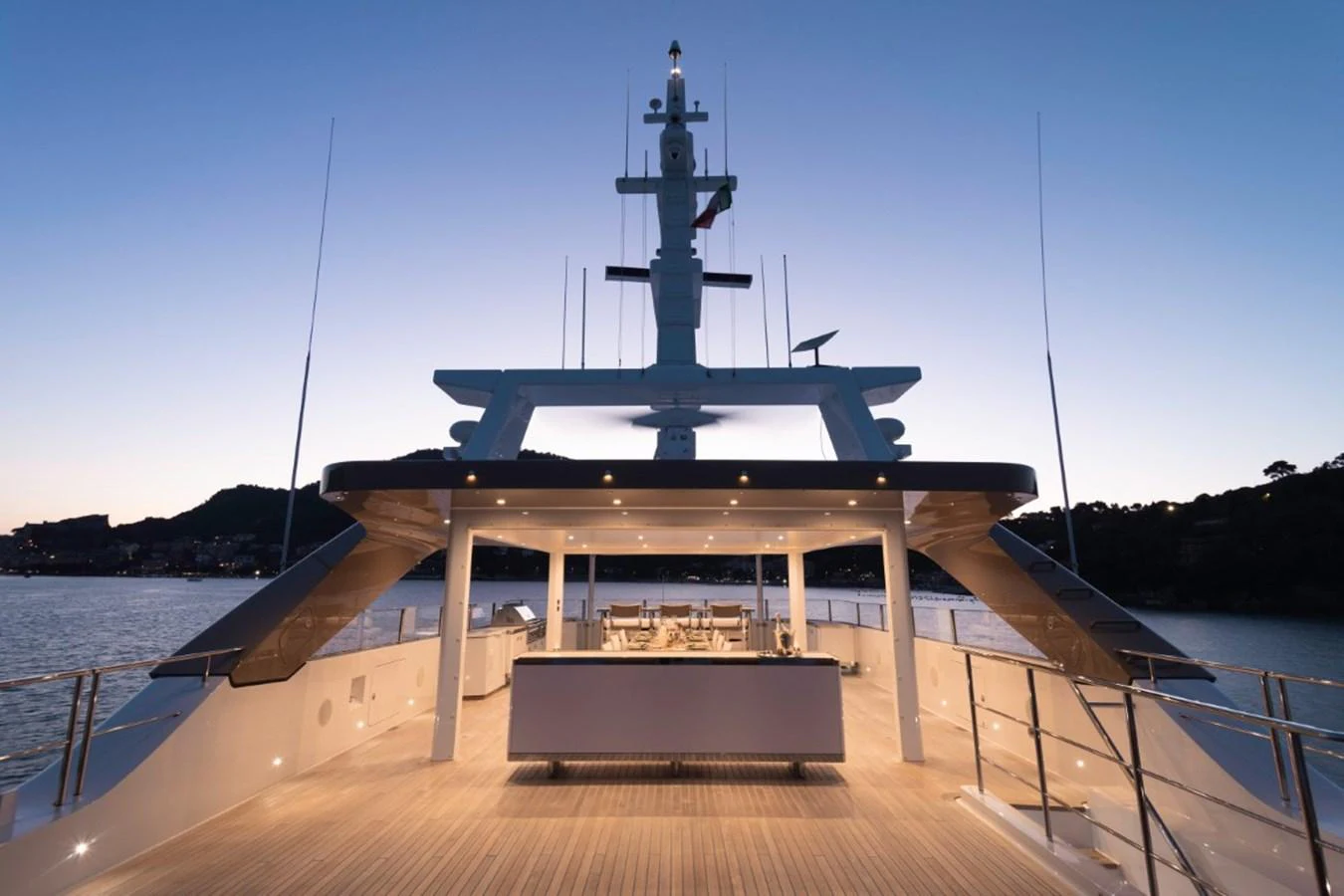 The aft deck of this yacht offers a spacious and elegant area for relaxation and entertainment, beautifully lit at dusk. aboard PICK UP Yacht for Sale