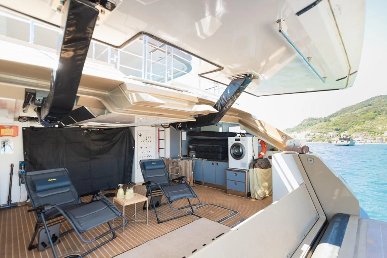 The aft deck features a comfortable lounging area with reclining chairs and a small table, perfect for relaxation. aboard PICK UP Yacht for Sale