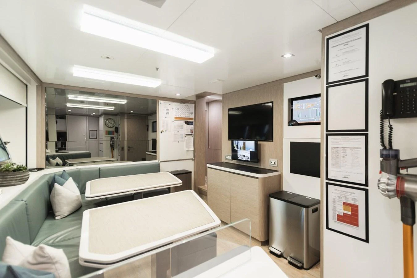 The yacht's interior features a cozy dining area with modern amenities and a comfortable seating arrangement. aboard PICK UP Yacht for Sale