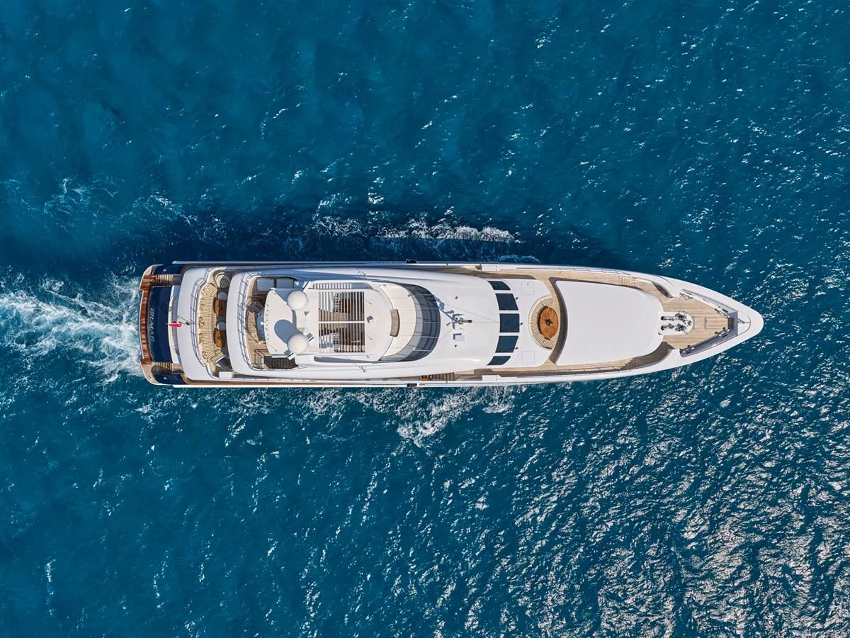 A stunning aerial view of a luxurious yacht cruising through the clear blue waters. aboard BILMAR Yacht for Sale