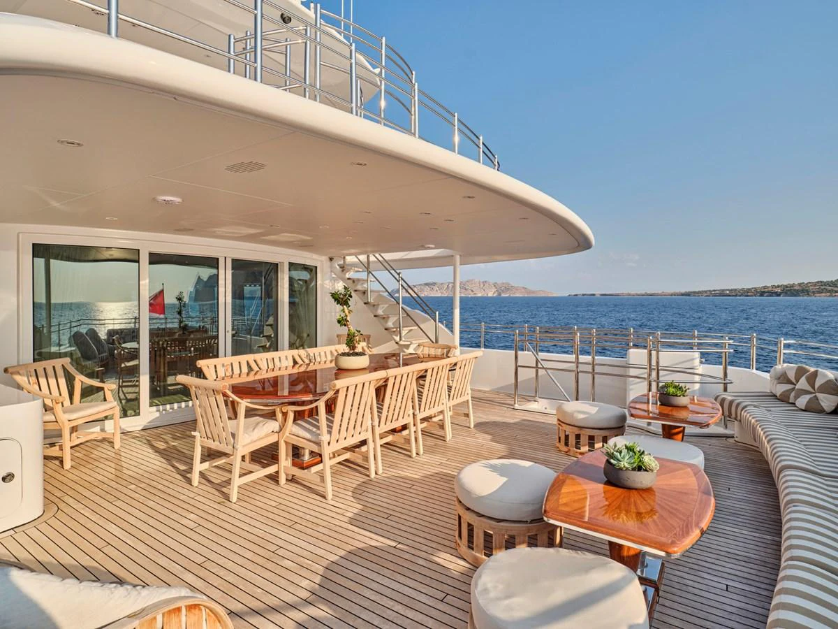 The aft deck features elegant outdoor dining and lounging areas with stunning sea views. aboard BILMAR Yacht for Sale