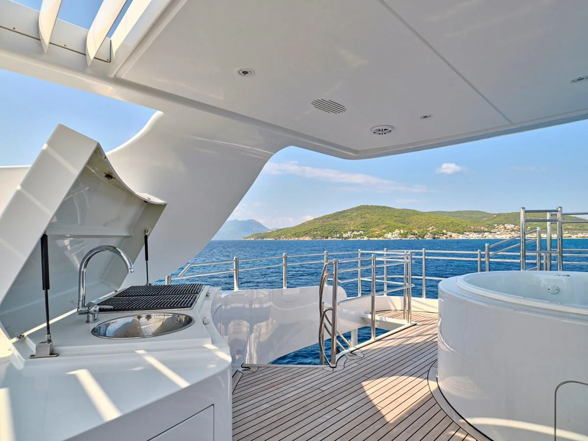 The sundeck features a barbecue grill and a jacuzzi with stunning ocean views. aboard BILMAR Yacht for Sale