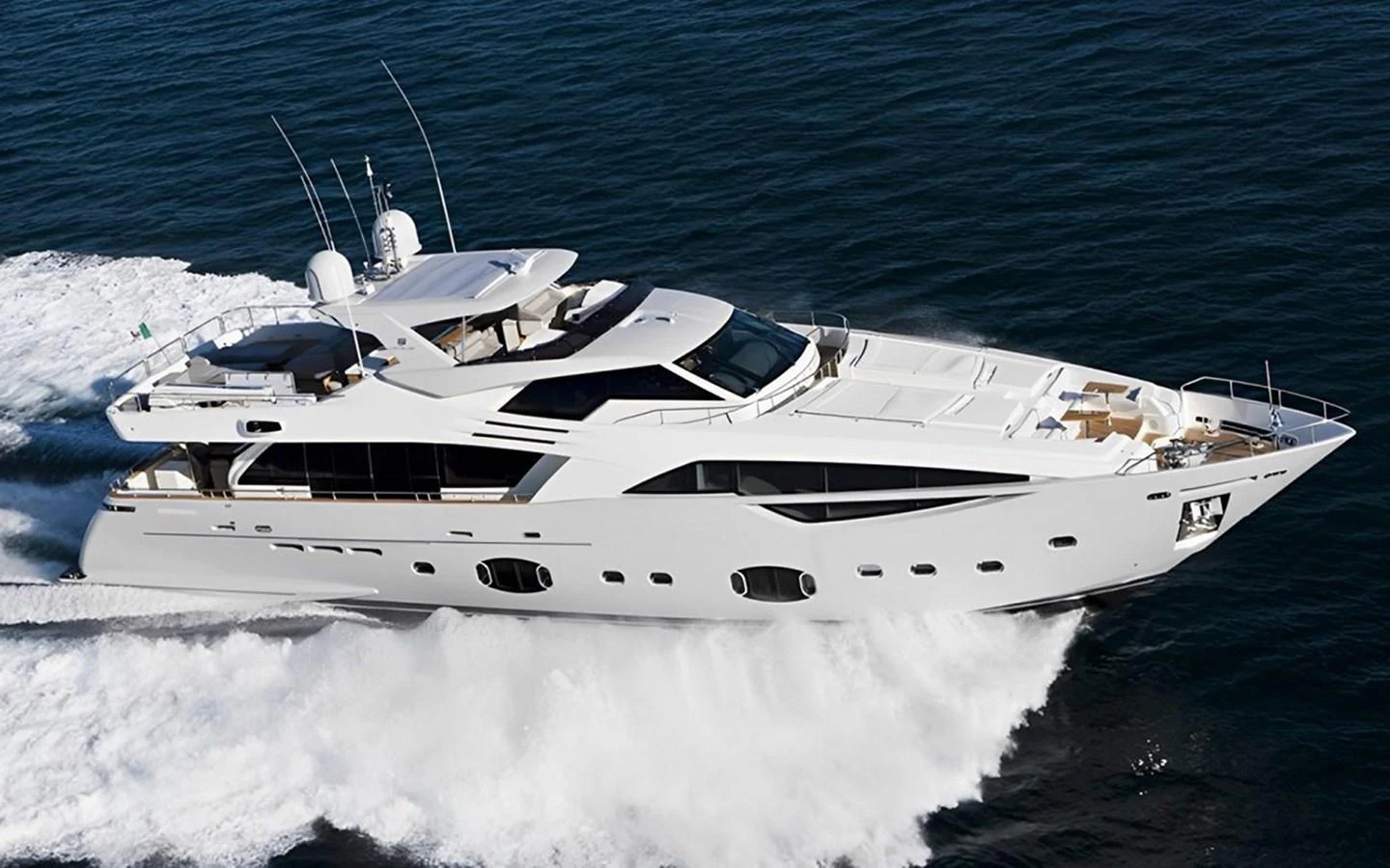 A sleek and modern yacht cruises swiftly through the water, showcasing its elegant design and powerful performance. aboard UHUD Yacht for Sale
