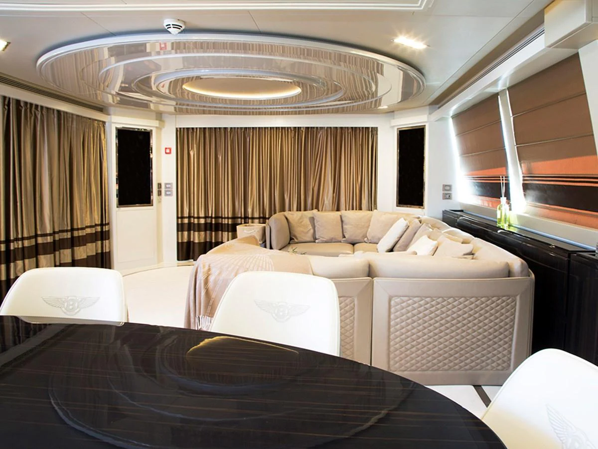 The luxurious salon features an elegant seating area with plush furnishings and modern decor. aboard UHUD Yacht for Sale