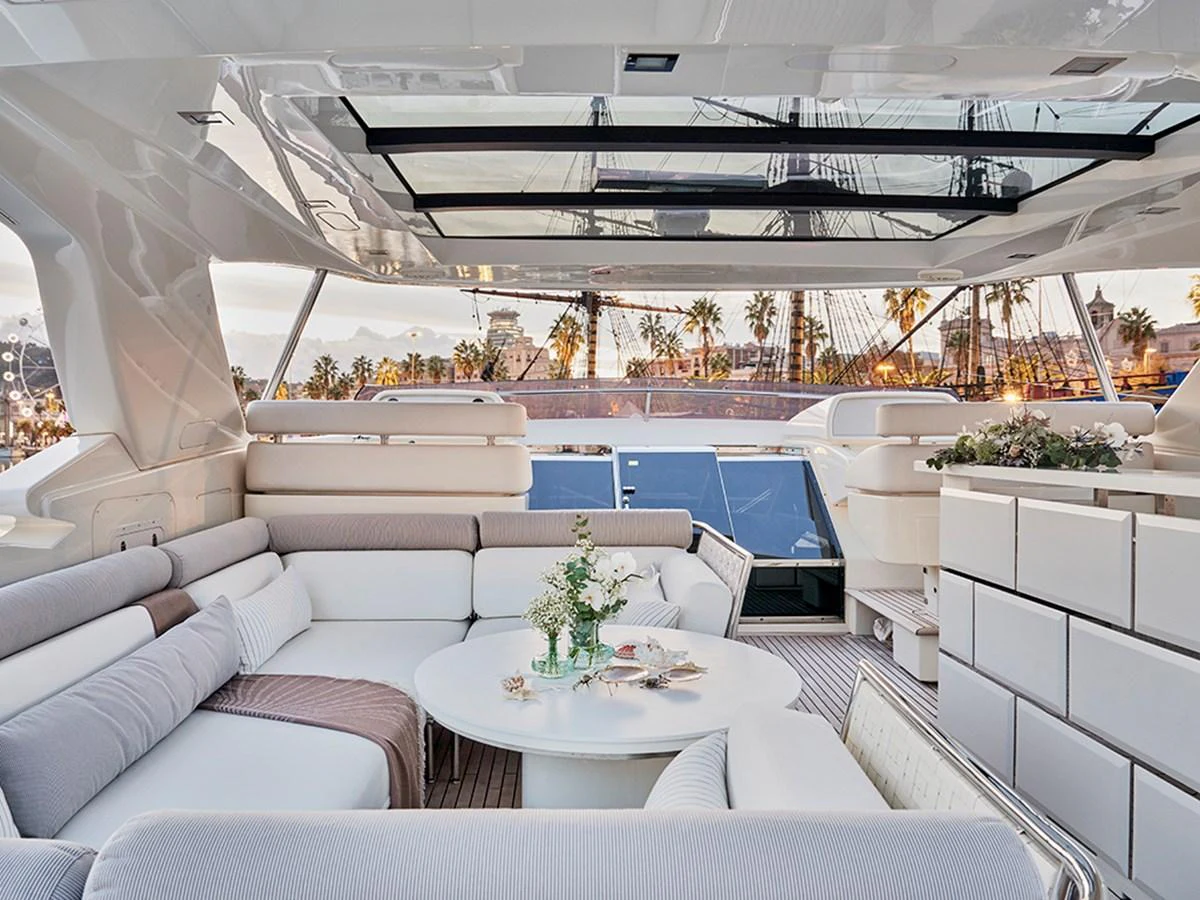 The salon offers a luxurious and spacious seating area with a panoramic view through large windows and a retractable roof. aboard UHUD Yacht for Sale