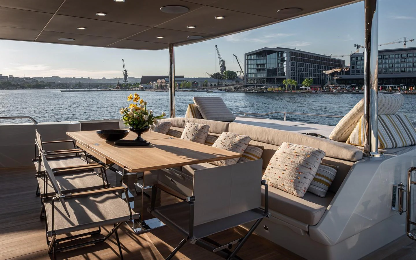 The aft deck features a stylish dining area with comfortable seating and a scenic view. aboard NUMARINE 27XP#6 Yacht for Sale