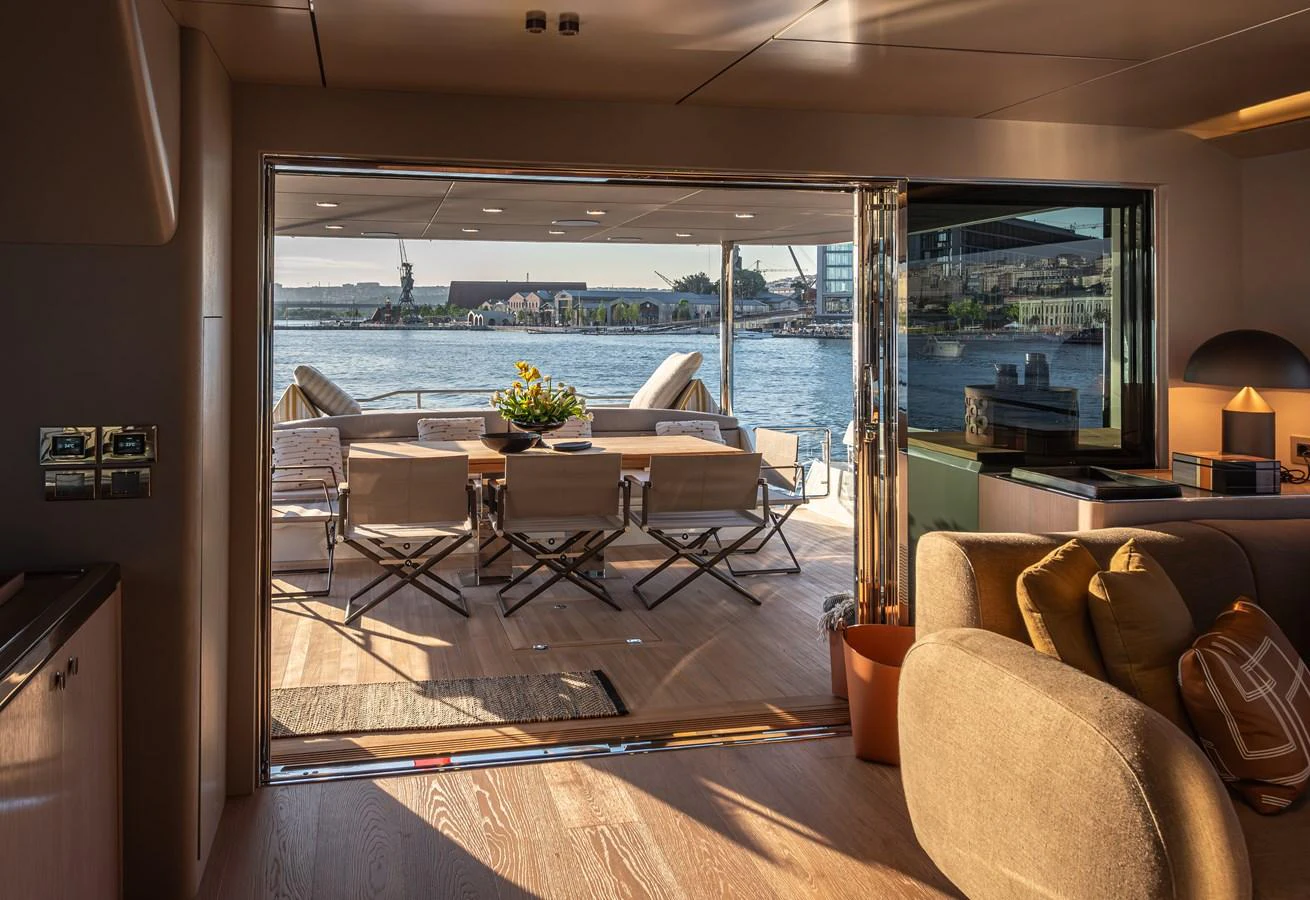 The salon opens up to an inviting aft deck with a dining area overlooking the water. aboard NUMARINE 27XP#6 Yacht for Sale