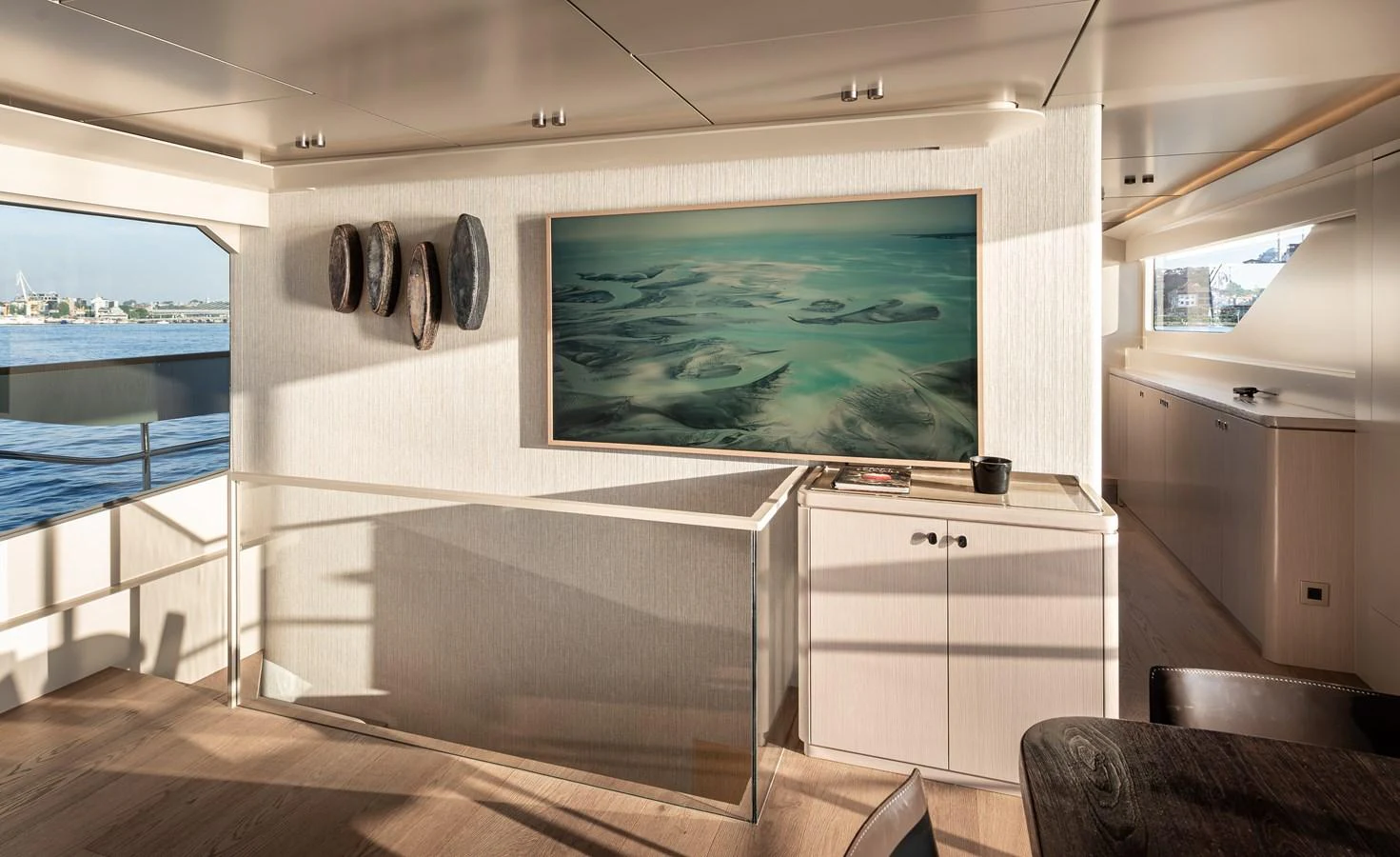 The salon features a large flat-screen TV and modern decor with ample natural light. aboard NUMARINE 27XP#6 Yacht for Sale