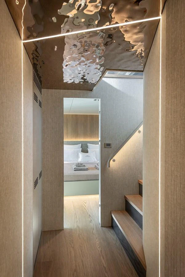 A modern hallway with a staircase leading to a cozy bedroom. aboard NUMARINE 27XP#6 Yacht for Sale