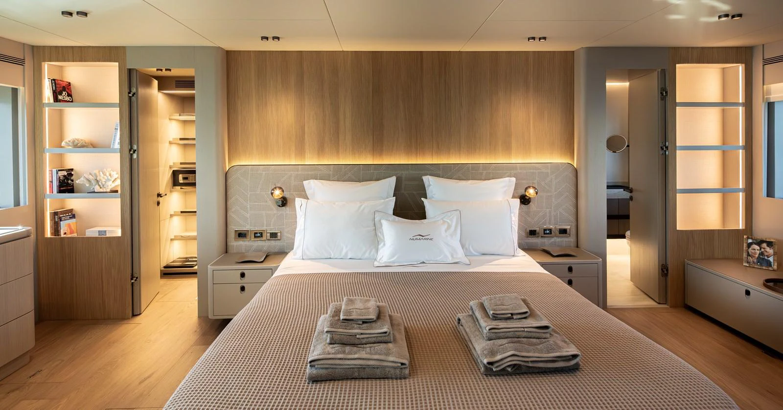 The master stateroom features a luxurious bed with elegant lighting and ample storage space. aboard NUMARINE 27XP#6 Yacht for Sale