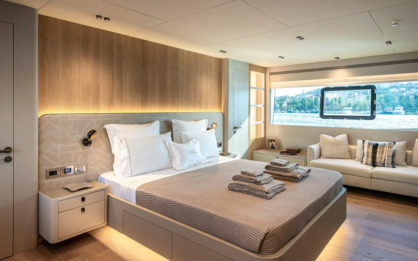 The master stateroom features a luxurious bed, modern lighting, and a scenic window view. aboard NUMARINE 27XP#6 Yacht for Sale