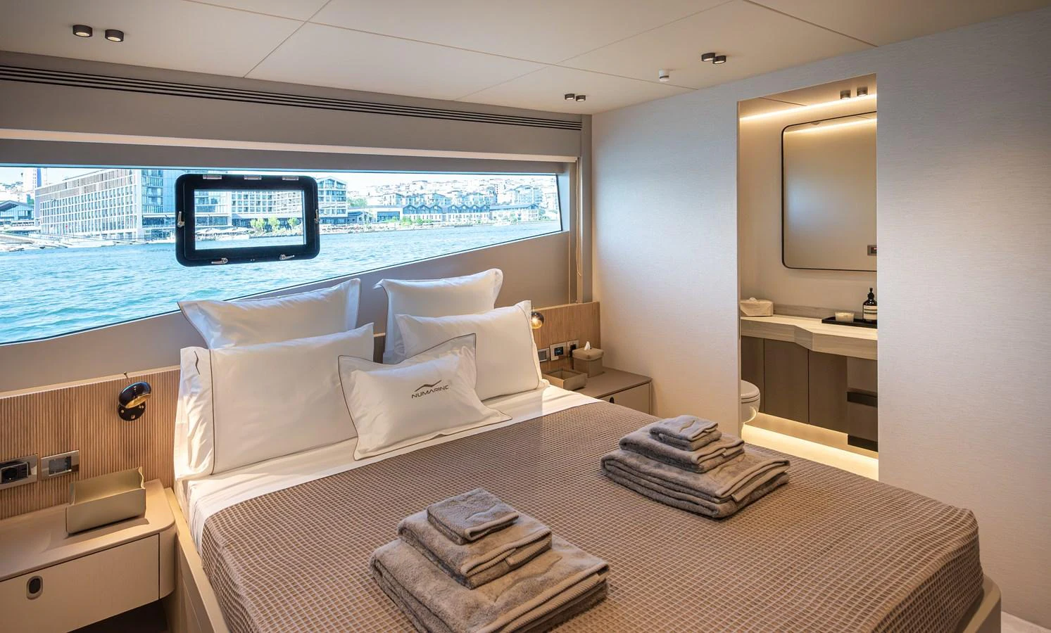 The stateroom offers a serene retreat with a large bed, ample natural light, and an en-suite bathroom. aboard NUMARINE 27XP#6 Yacht for Sale