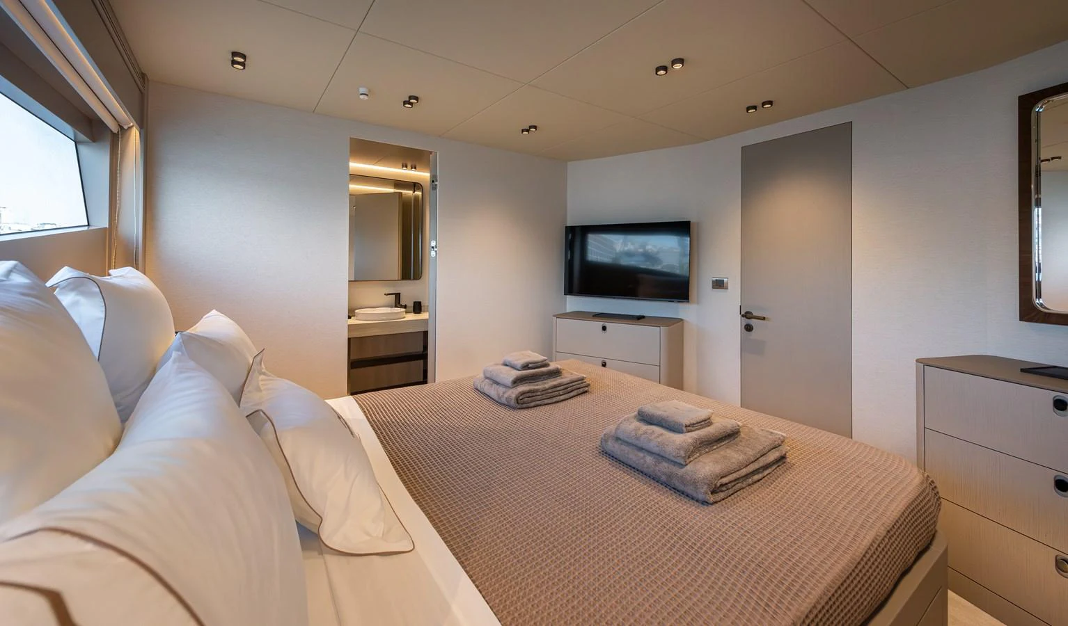 The master stateroom features a luxurious bed, modern decor, and an ensuite bathroom. aboard NUMARINE 27XP#6 Yacht for Sale