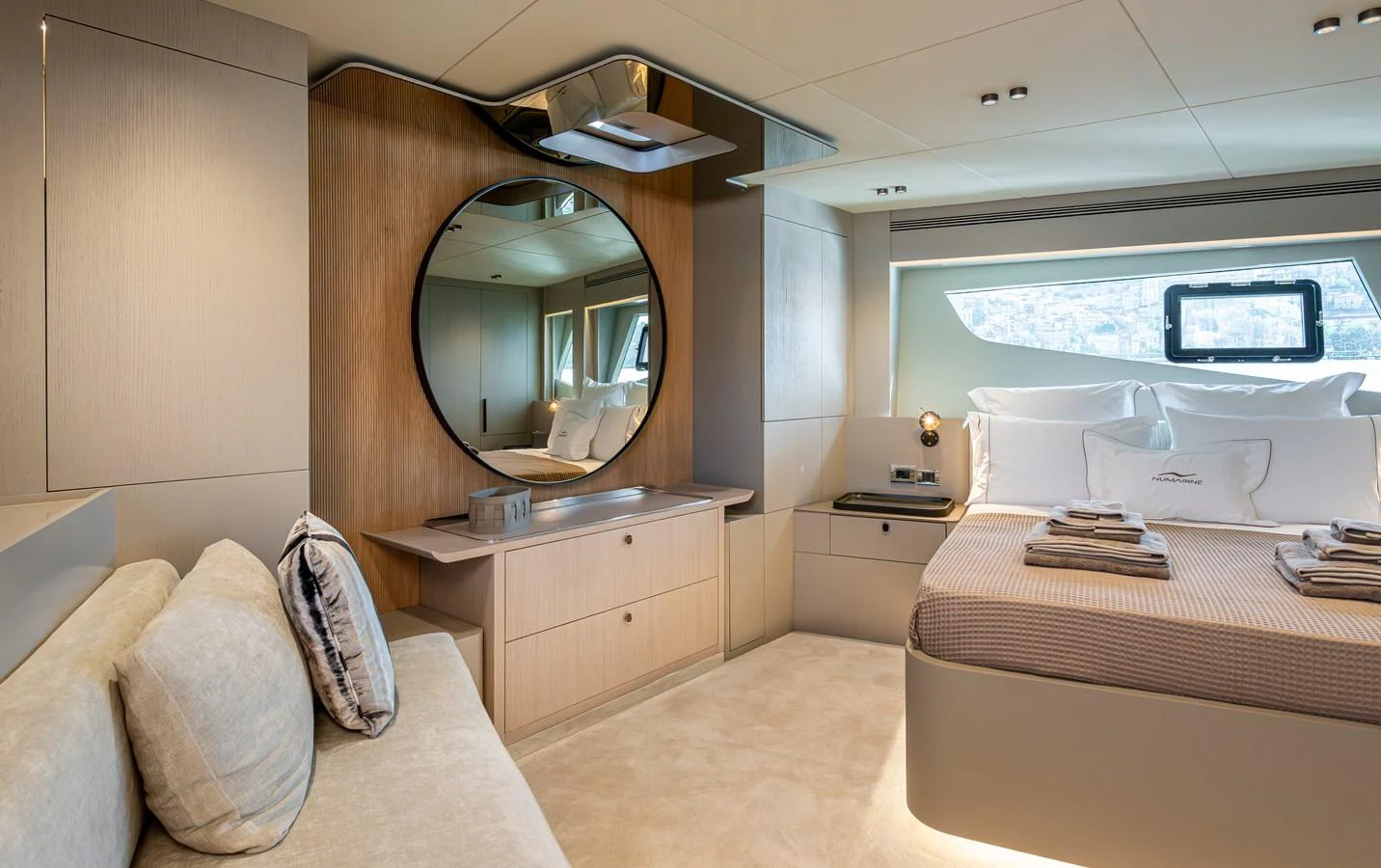 A luxurious stateroom featuring a comfortable bed, modern decor, and ample natural light. aboard NUMARINE 27XP#6 Yacht for Sale
