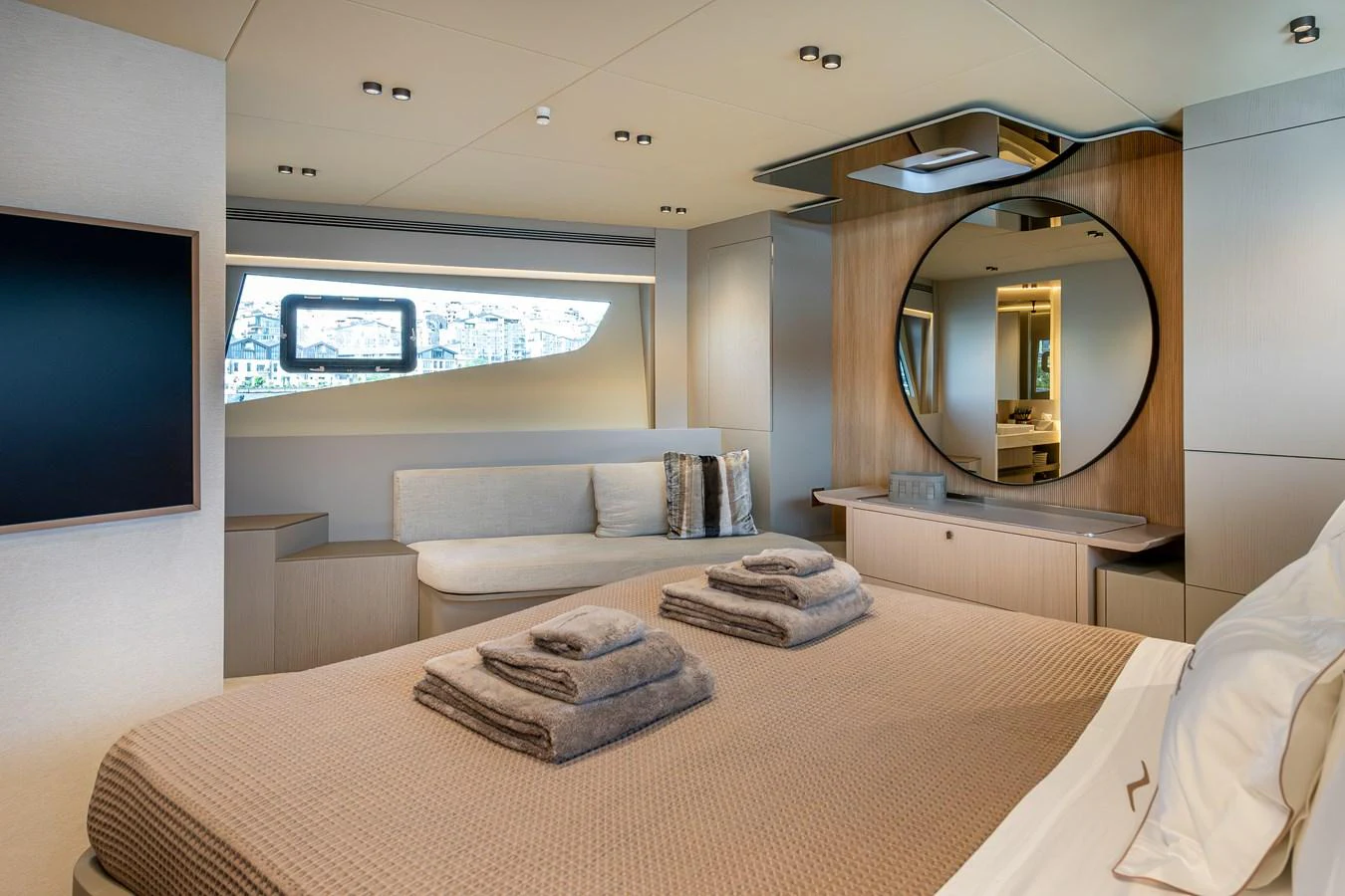 The master stateroom features a luxurious bed, modern decor, and ample natural light. aboard NUMARINE 27XP#6 Yacht for Sale