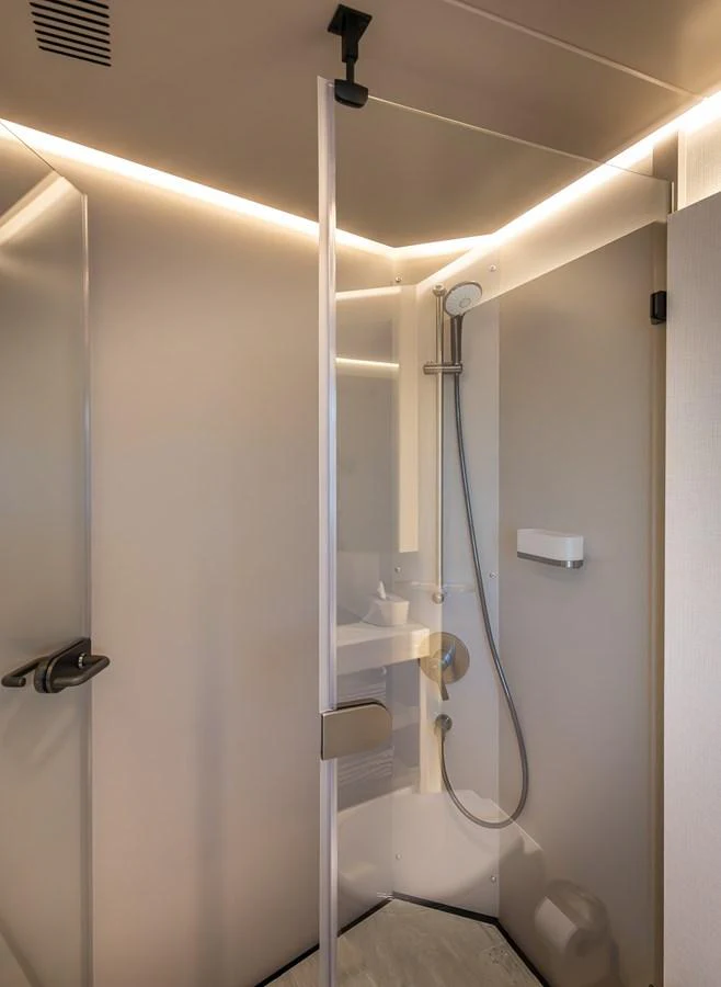 The yacht's bathroom features a sleek, modern shower with elegant lighting. aboard NUMARINE 27XP#6 Yacht for Sale