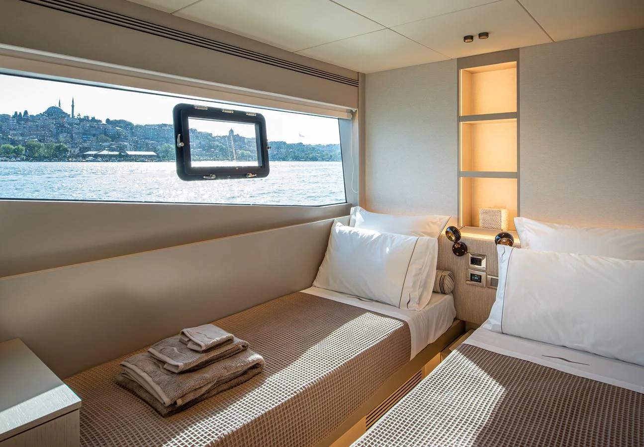 The guest stateroom features twin beds with a scenic view through the window. aboard NUMARINE 27XP#6 Yacht for Sale