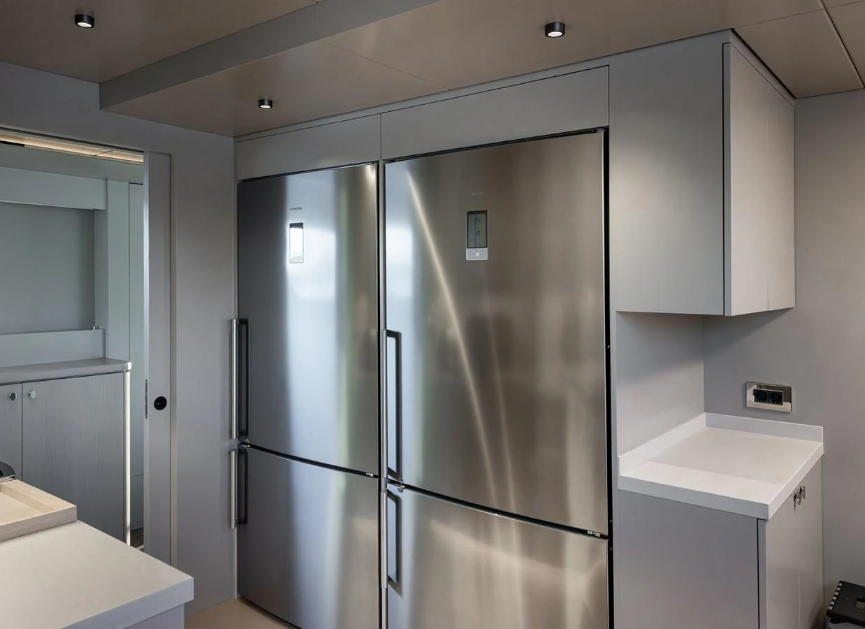 The yacht's galley features modern stainless steel appliances and sleek cabinetry. aboard NUMARINE 27XP#6 Yacht for Sale