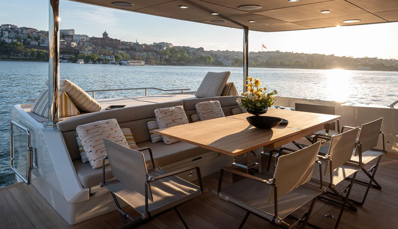 The aft deck features a stylish dining area with comfortable seating and scenic views. aboard NUMARINE 27XP#6 Yacht for Sale