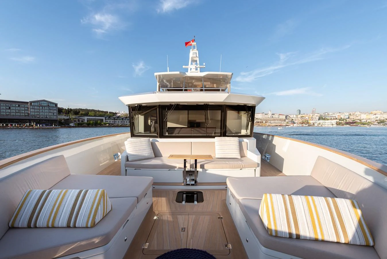 The foredeck of the yacht features comfortable seating and sunbathing areas with a scenic backdrop. aboard NUMARINE 27XP#6 Yacht for Sale