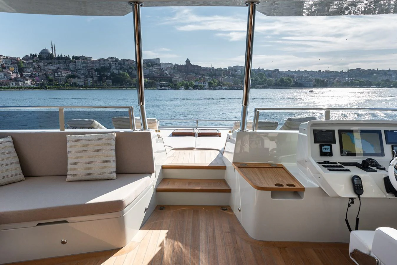 The aft deck offers a serene space with comfortable seating and a view of the water and cityscape. aboard NUMARINE 27XP#6 Yacht for Sale