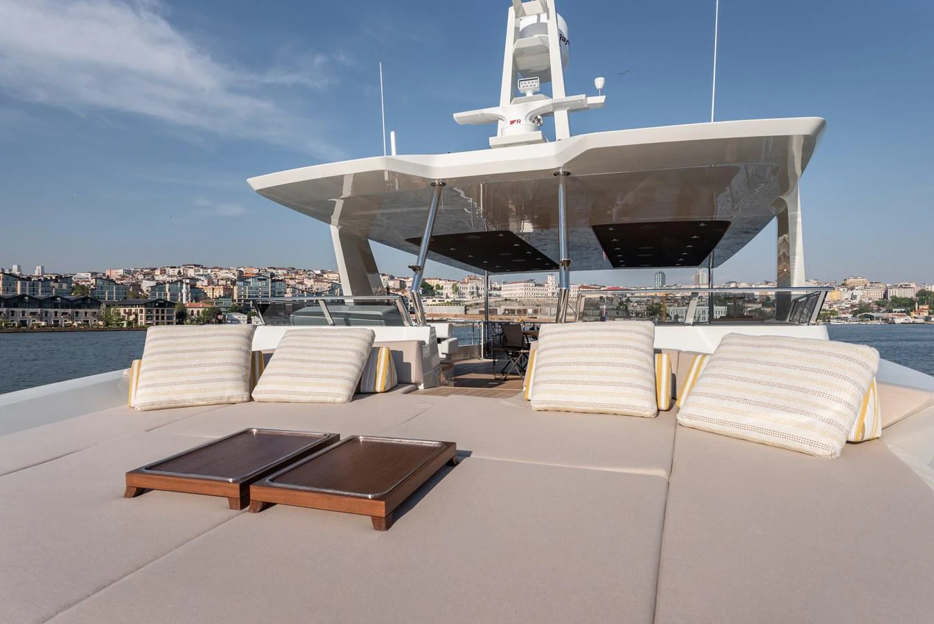 The sundeck offers a spacious lounging area with plush cushions and a stunning view of the surroundings. aboard NUMARINE 27XP#6 Yacht for Sale
