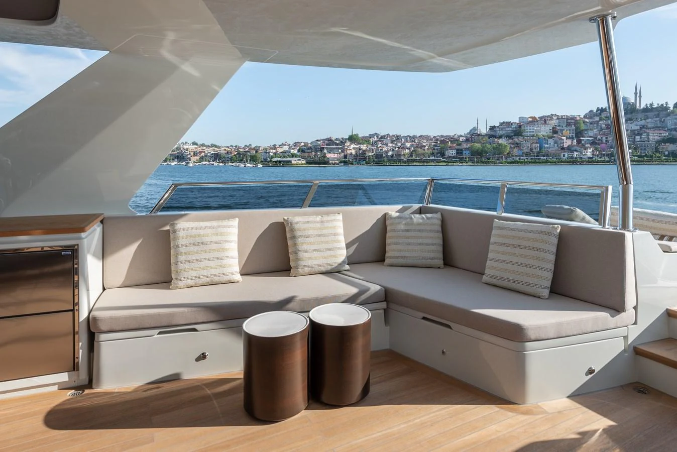 The aft deck offers a comfortable seating area with a scenic view of the water and nearby town. aboard NUMARINE 27XP#6 Yacht for Sale