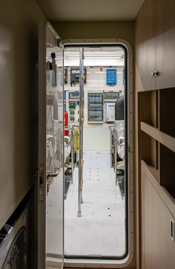 The image showcases the entrance to a well-organized engine room, highlighting the yacht's technical sophistication. aboard NUMARINE 27XP#6 Yacht for Sale