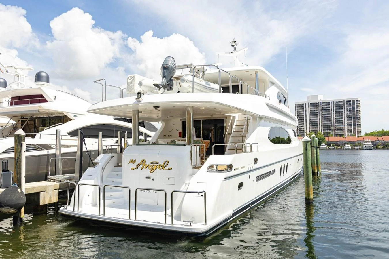 The yacht is docked, showcasing its spacious aft deck and elegant design. aboard MY ANGEL Yacht for Sale
