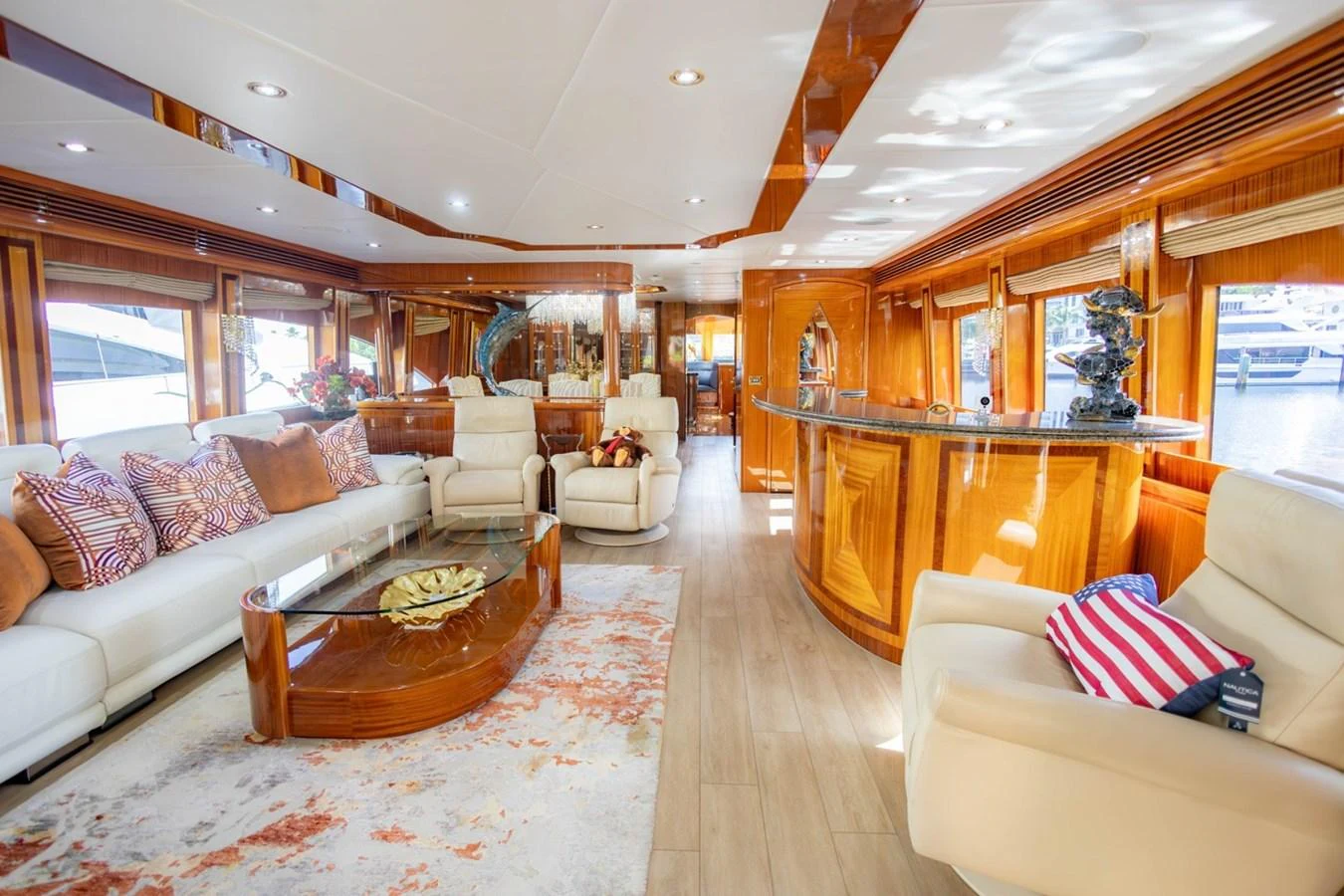 The yacht's salon features luxurious seating, elegant wood finishes, and ample natural light. aboard MY ANGEL Yacht for Sale