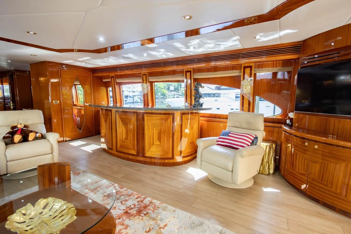 The salon features luxurious seating, a large flat-screen TV, and elegant wood finishes. aboard MY ANGEL Yacht for Sale