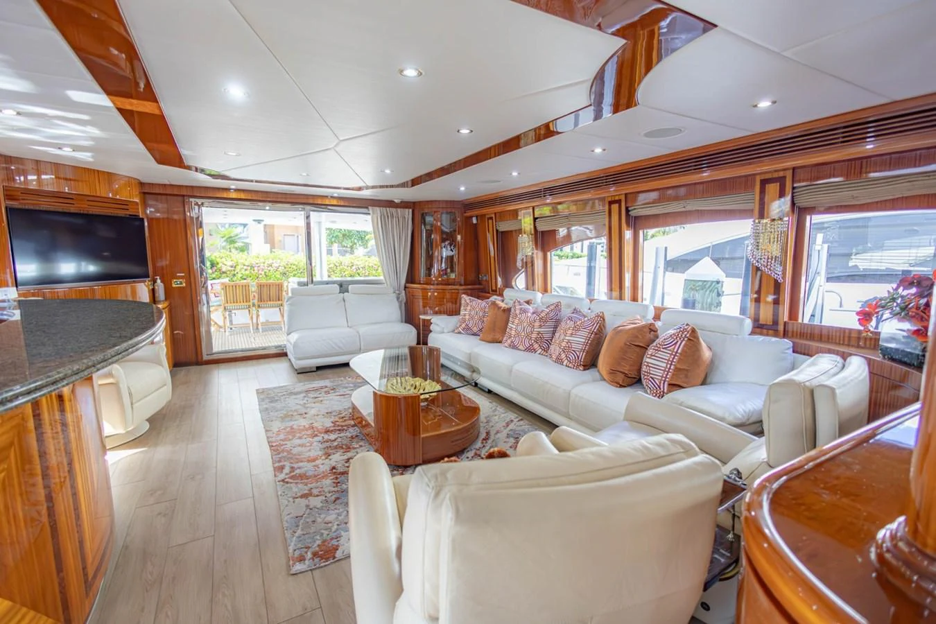 The yacht's salon features luxurious seating, elegant wood finishes, and ample natural light. aboard MY ANGEL Yacht for Sale