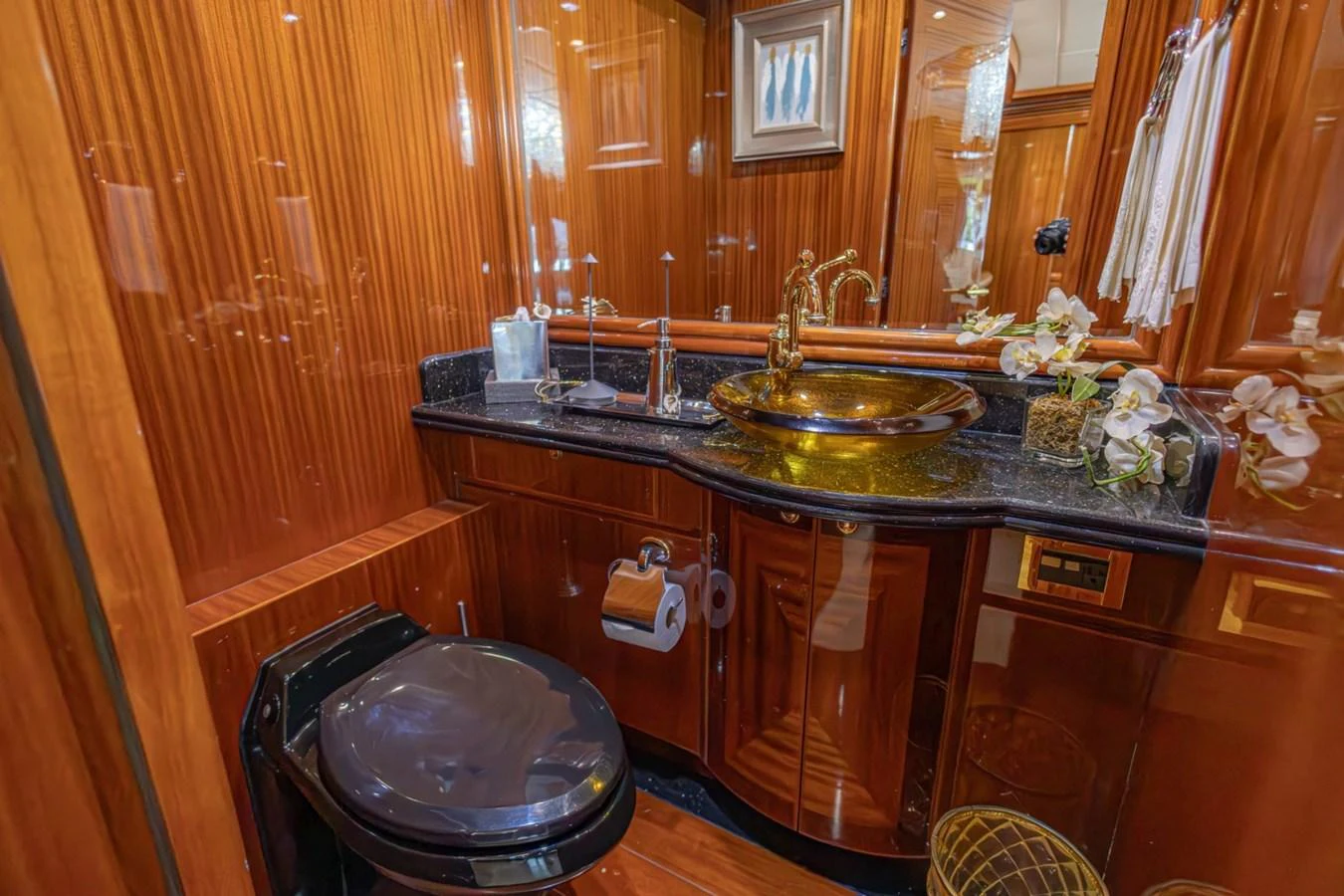 A luxurious yacht bathroom featuring elegant wood paneling and a stylish sink area. aboard MY ANGEL Yacht for Sale