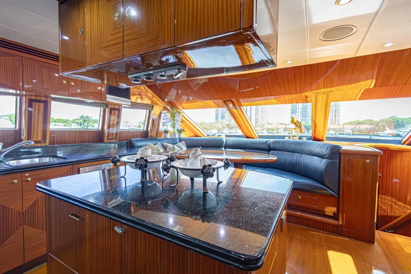 The yacht's galley features elegant wood finishes and a spacious seating area with panoramic windows. aboard MY ANGEL Yacht for Sale
