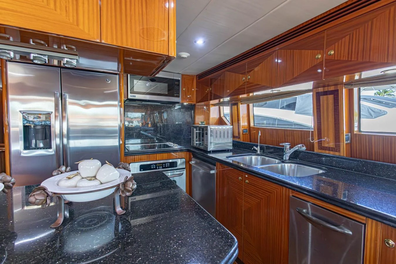The yacht's galley features modern stainless steel appliances and rich wooden cabinetry. aboard MY ANGEL Yacht for Sale