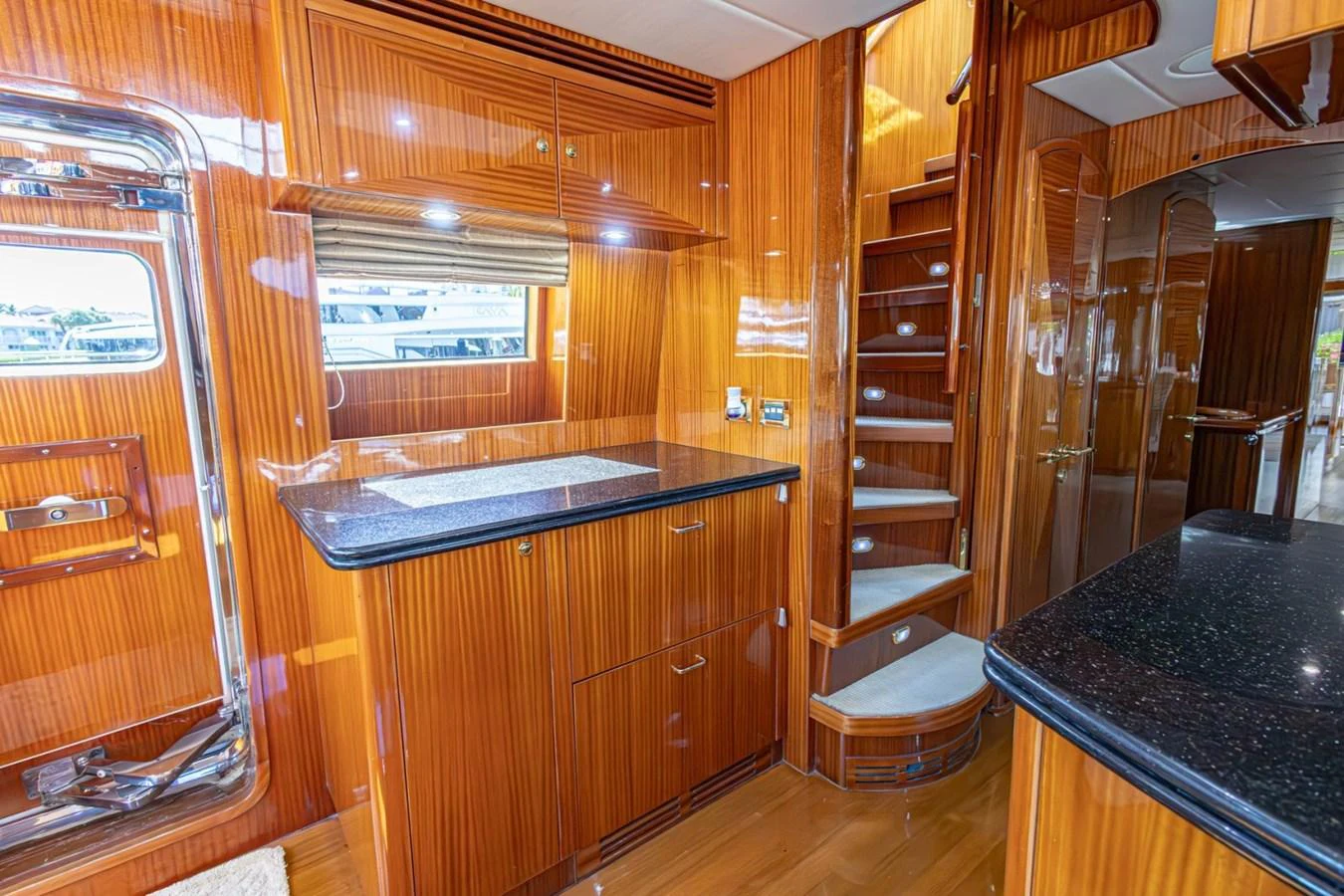 The yacht's galley features rich wood cabinetry and modern appliances, creating a warm and functional space. aboard MY ANGEL Yacht for Sale