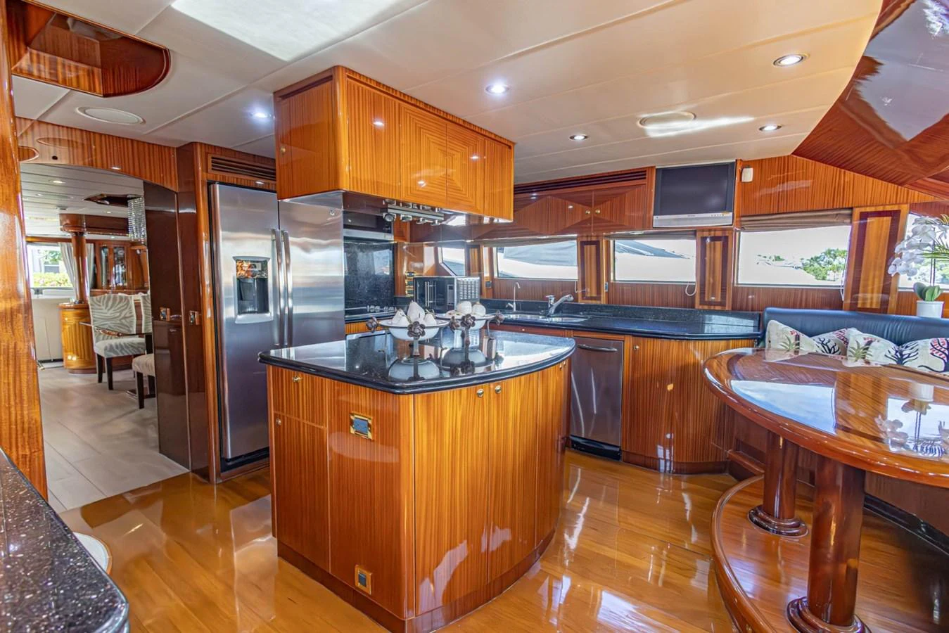 The galley features rich wood finishes, modern appliances, and ample natural light. aboard MY ANGEL Yacht for Sale